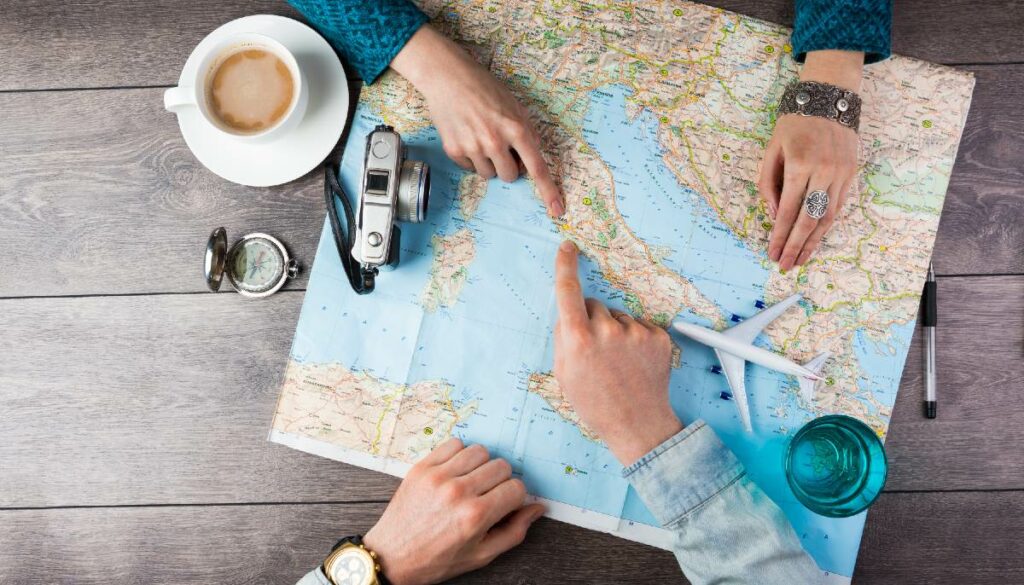 two people pointing at map